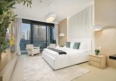 a bedroom with a white bed and a large window at Royal Vista - Luxury 2BR Apartment with Burj Khalifa View at Burj Vista - Downtown in Dubai