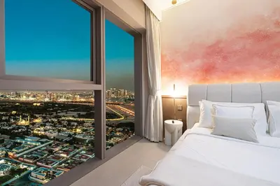 a bedroom with a view of a city at Downtown Chic 2 Bedroom Apartment I Dubai Mall Access I Views of Burj Khalifa from Pool I Free Parking, Gym, Pool & Wi-Fi I by Meerak in Dubai