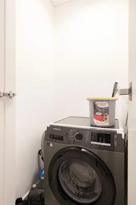a washing machine with a box on top of it at Downtown Chic 2 Bedroom Apartment I Dubai Mall Access I Views of Burj Khalifa from Pool I Free Parking, Gym, Pool & Wi-Fi I by Meerak in Dubai
