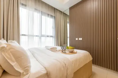 a bedroom with a white bed with a table on it at KeyRock Luxury Apartment at Aykon Tower with Views in Dubai