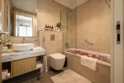 a bathroom with a sink and a toilet and a tub at KeyRock Luxury Apartment at Aykon Tower with Views in Dubai