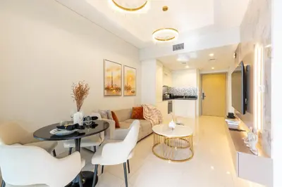 a living room with a couch and a table and chairs at KeyRock Luxury Apartment at Aykon Tower with Views in Dubai