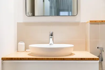 a bathroom with a sink and a mirror at SettlerHomes - Idyllic Dubai Hills Stay Near Parkside in Dubai