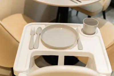 a table with a plate and utensils on top of a toilet at SettlerHomes - Idyllic Dubai Hills Stay Near Parkside in Dubai
