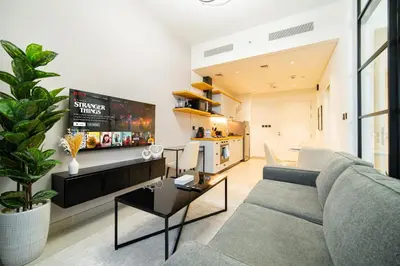 a living room with a couch and a tv at SettlerHomes - Idyllic Dubai Hills Stay Near Parkside in Dubai