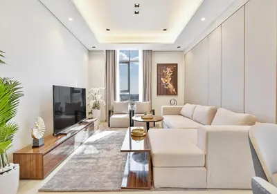 a living room with a white couch and a tv at 2BR Central Apt in Business Bay Noble Tower in Dubai