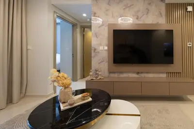 a living room with a table and a tv at Keyrock Living - Luxury Stay in Business Bay in Dubai