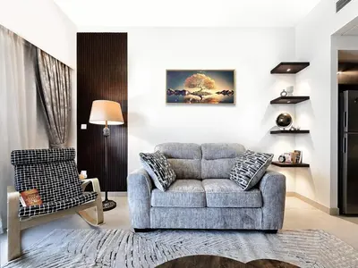 a living room with a couch and a chair at Near Burj Khalifa, Dubai Fountain, Dubai Mall in Downtown in Dubai