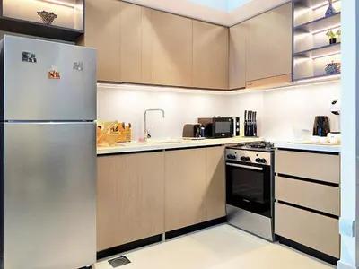 a kitchen with a stainless steel refrigerator and appliances at Near Burj Khalifa, Dubai Fountain, Dubai Mall in Downtown in Dubai
