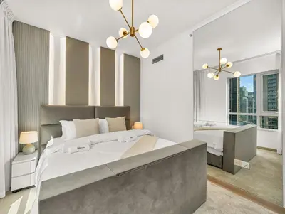 a bedroom with a large bed and a desk at WonderfulStay at The Residences - Best Burj Khalifa & Fountain View - Brand New Luxury Apartments in Dubai