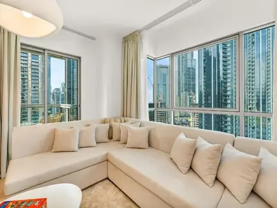 a living room with a large couch and large windows at WonderfulStay at The Residences - Best Burj Khalifa & Fountain View - Brand New Luxury Apartments in Dubai