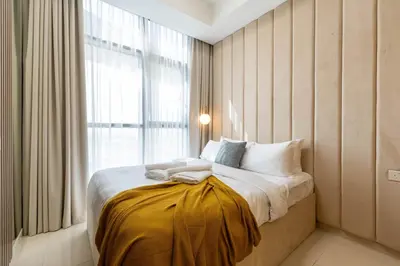 a bedroom with a large bed with a window at Keyrock Stylish Apartment in Dubai with Pool and Gym in Dubai