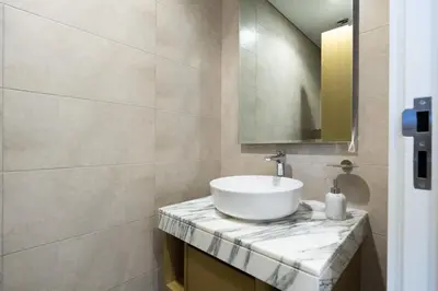 a bathroom with a sink and a mirror at KeyRock Elegant Aykon Apartment with City Views in Dubai