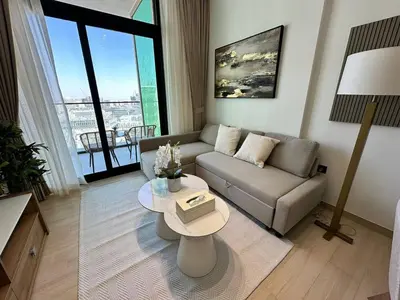 a living room with a couch and a table at Cozy 1br Apartment In Jvc Free Parking & Pool in Dubai