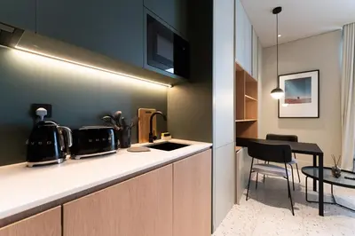 a kitchen with a counter top and a table at Upside living business bay best in Dubai