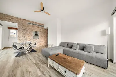 a living room with a couch and a table at Pool View 1BR in Dubai Free Parking Gym Near Parks and Golf in Dubai