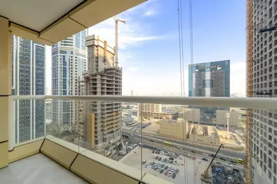 a view of a city from a balcony in a building at Stylish 1BR with Balcony Near Marina Mall, Pool & Free Parking in Dubai