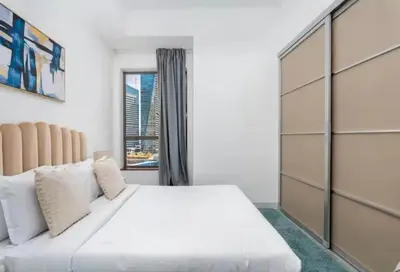a bedroom with a large white bed and a window at Ahlan Premium Spacious Luxury Furnished 2 Bedroom Apartment Marina Beach JBR for Families and Groups in Dubai