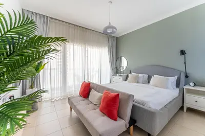 a bedroom with a large bed and a couch at HAVN - Studio in Downtown, 10mins to Dubai Mall in Dubai