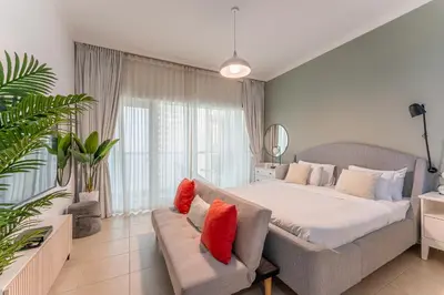 a bedroom with a large bed and a couch at HAVN - Studio in Downtown, 10mins to Dubai Mall in Dubai