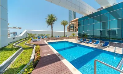 a swimming pool on the roof of a building at HAVN - Studio in Downtown, 10mins to Dubai Mall in Dubai
