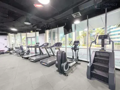 a gym with rows of treadmills and elliptical machines at Stylish & Modern 3BR Apartment in Marina Stunning Views in Dubai