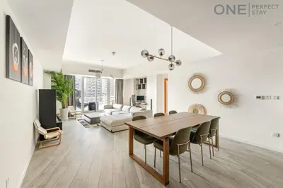 a living room with a table and a couch at Stylish & Modern 3BR Apartment in Marina Stunning Views in Dubai