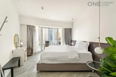a bedroom with a large white bed and large windows at Stylish & Modern 3BR Apartment in Marina Stunning Views in Dubai