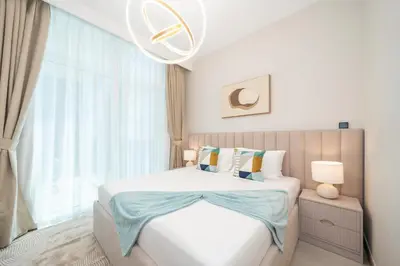 a bedroom with a bed and a large window at Stylish 2BR Fully Furnished Unit at Business Bay in Dubai