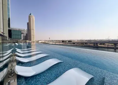 a row of white seats on the roof of a building at Stylish 2BR Fully Furnished Unit at Business Bay in Dubai