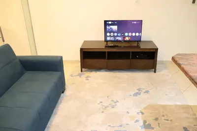 a living room with a couch and a tv at Panoramic Marina View in Dubai