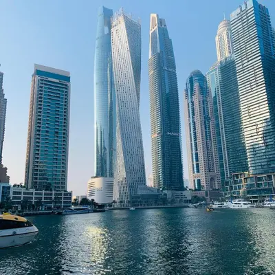 a group of tall buildings in a city with a river at Panoramic Marina View in Dubai