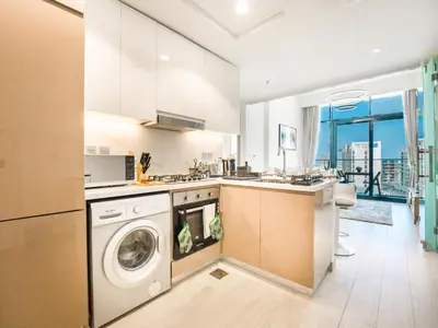 a kitchen with a washer and a dishwasher at EasyGo- Splendid Apartments in Al Meydan Living in Dubai