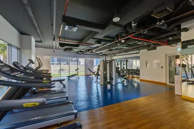 a gym with a bunch of treadmills at Burj Khalifa View - 1BR in Bellevue Tower 2, Downtown - Allsopp & Allsopp in Dubai