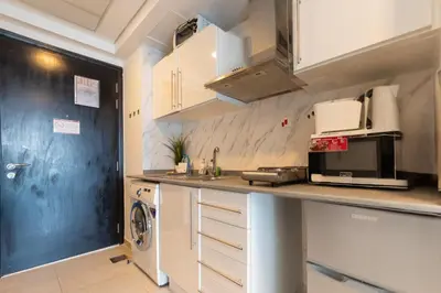 a kitchen with a counter top with a microwave at HAVN - Studio Apartment in Goldcrest Views, JLT in Dubai
