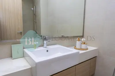 a bathroom with a white sink and a mirror at Bloomfields Cozy Stu Azizi Farhad in Dubai