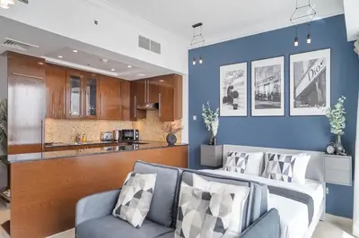 a living room with a couch and a kitchen at HAVN - Studio in 8 Boulevard, Downtown Dubai in Dubai