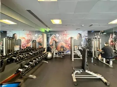 a gym with lots of tread machines and a mural at HAVN - Studio in 8 Boulevard, Downtown Dubai in Dubai