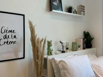 a bedroom with a bed and a picture on the wall at ASHRI HH, Bohemian Style Condo in Downtown in Dubai