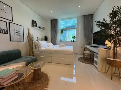 a bedroom with a bed and a desk in it at ASHRI HH, Bohemian Style Condo in Downtown in Dubai