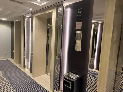 a elevator in a building with a bunch of mirrors at ASHRI HH, Bohemian Style Condo in Downtown in Dubai