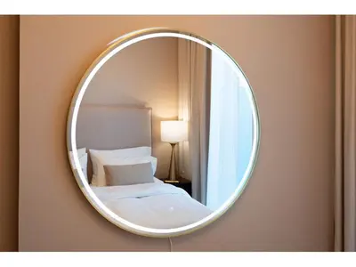 a mirror on a wall with a bed in a room at KeyRock Living - Stylish 1BR with Pool Access in Dubai