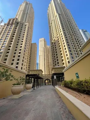 a walkway in a city with tall buildings at HAVN - Studio in Murjan JBR, 5mins to JBR Beach in Dubai
