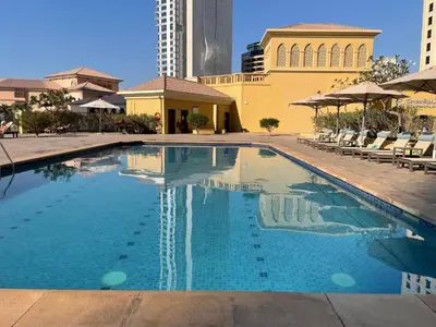 a swimming pool in front of a building at HAVN - Studio in Murjan JBR, 5mins to JBR Beach in Dubai