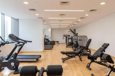 a gym with several treadmills and exercise bikes at GuestReady - Charming studio in Dubai Marina in Dubai