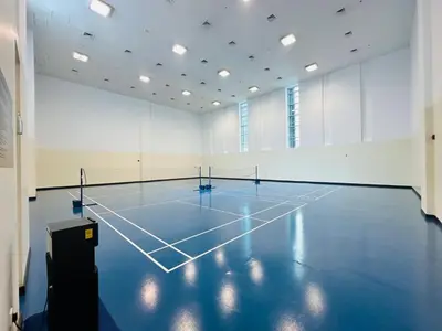 an empty gym with a tennis court in a room at Studio APT with Pool, Gym, Squash and Badminton Courts in Dubai