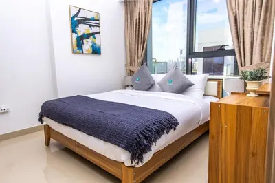 a bedroom with a bed with a large window at Bloomfields Modern 2br Azizi Gardens in Dubai