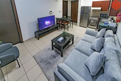 a living room with a couch and a tv at Calm 1bdr apartment in JVC in Dubai