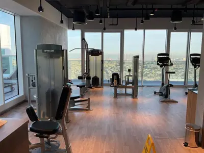 a gym with treadmills and exercise equipment in a building at Vogue Al Wasl 1 Residences Near Zabeel Park and World Trade Centre, One Bedroom Apartment with Balcony and City View, Access to all Amenities, Walkable to Max Fashion Metro Station in Dubai