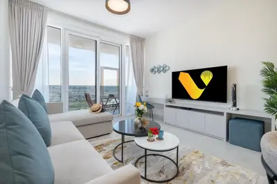 a living room with a couch and a tv at Vogue Al Wasl 1 Residences Near Zabeel Park and World Trade Centre, Two Bedroom Apartment with Balcony offering Dubai Frame and City View, Access to all Amenities, Walkable to Max Fashion Metro Station in Dubai